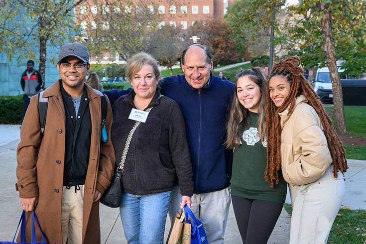 Family members smile on campus
