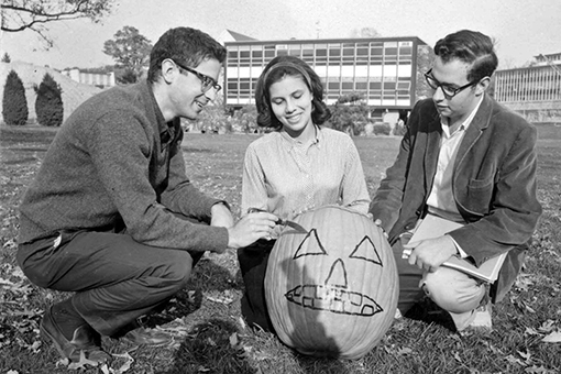 Black and white archival image of past Brandeis students carving pumpkins
