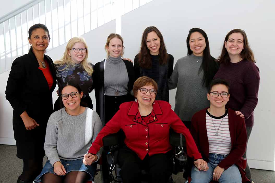 A group of people smile for the camera