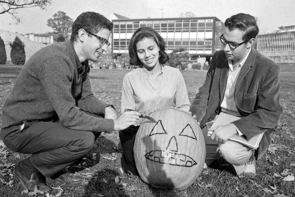 People carve pumpkins