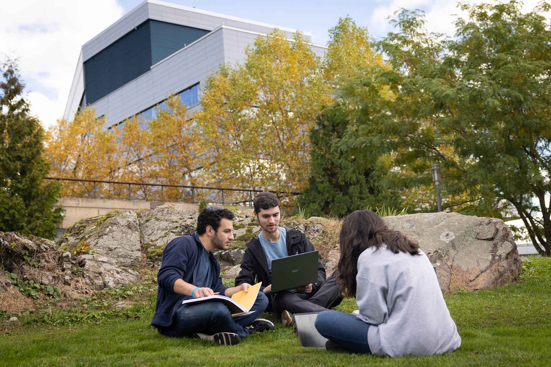 Students study on the lawn of Fellows Garden
