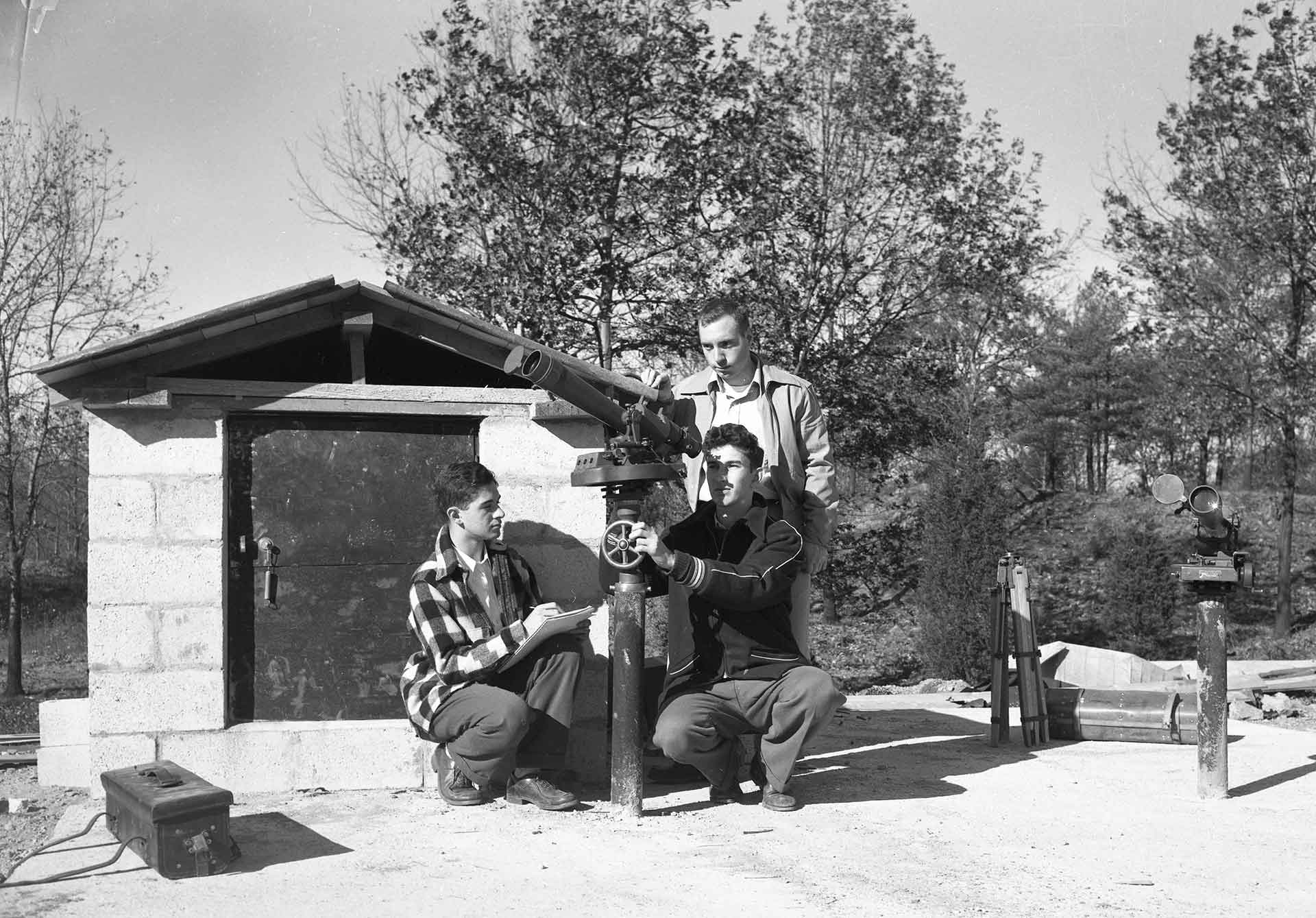 Students look through telescope