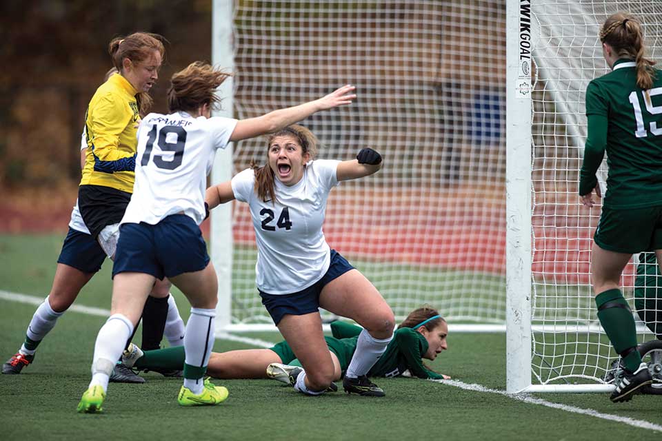 Brandeis soccer players celebrate victory on the field