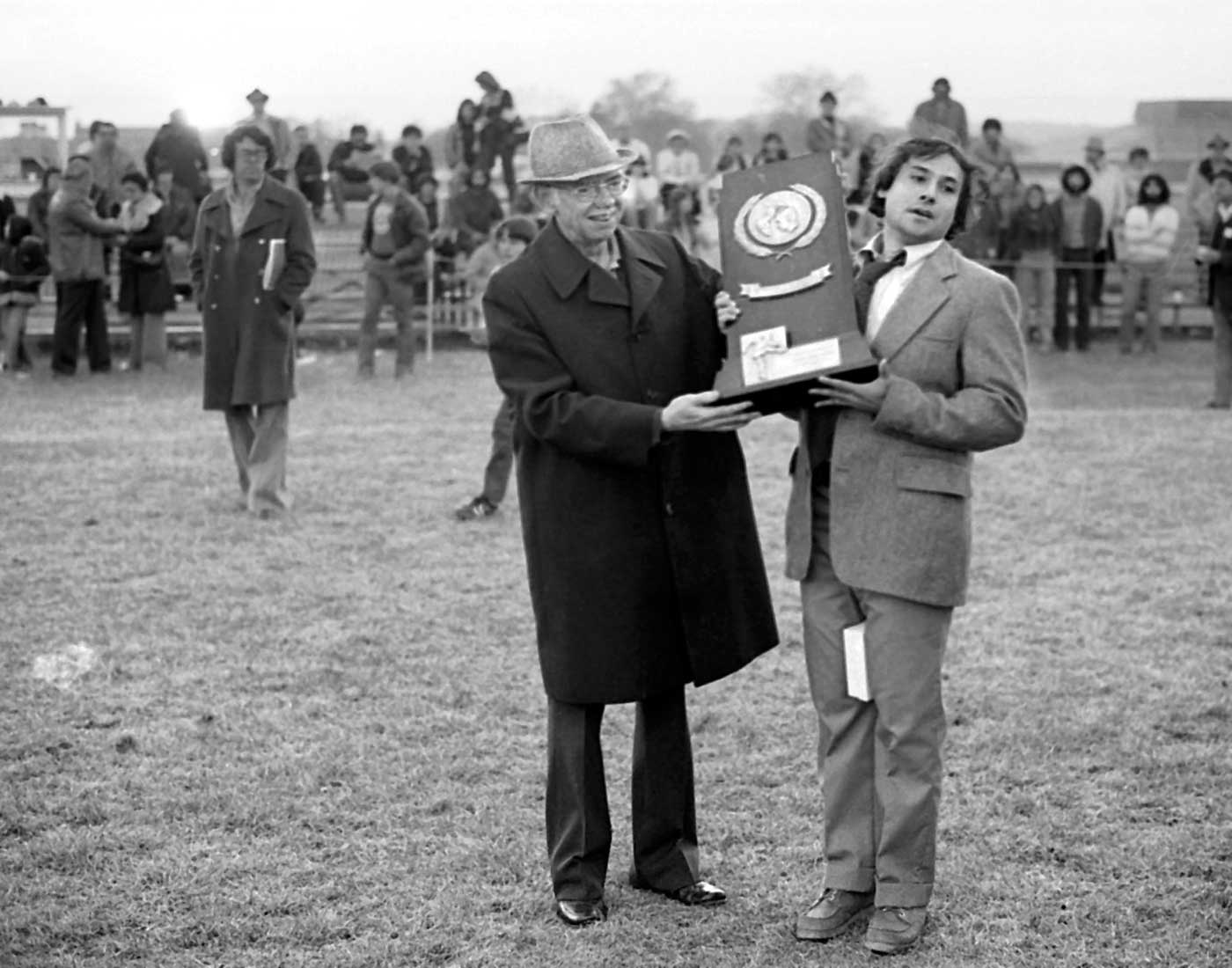 Men's soccer coach Mike Coven (right) accepts the NCAA Division III trophy