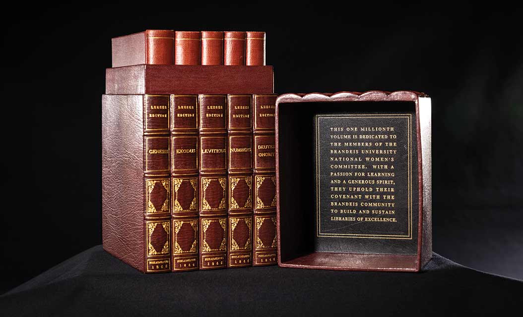 A brown leather case containing five leather books; the inside of the case's lid is inscribed in gold leaf.