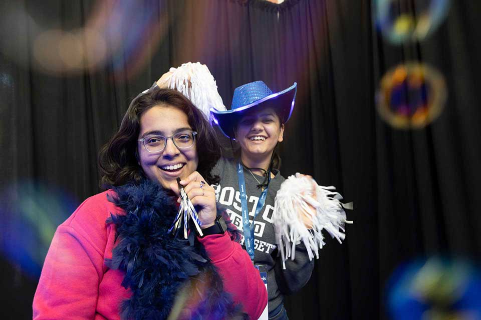 Two people with pom pom dance.