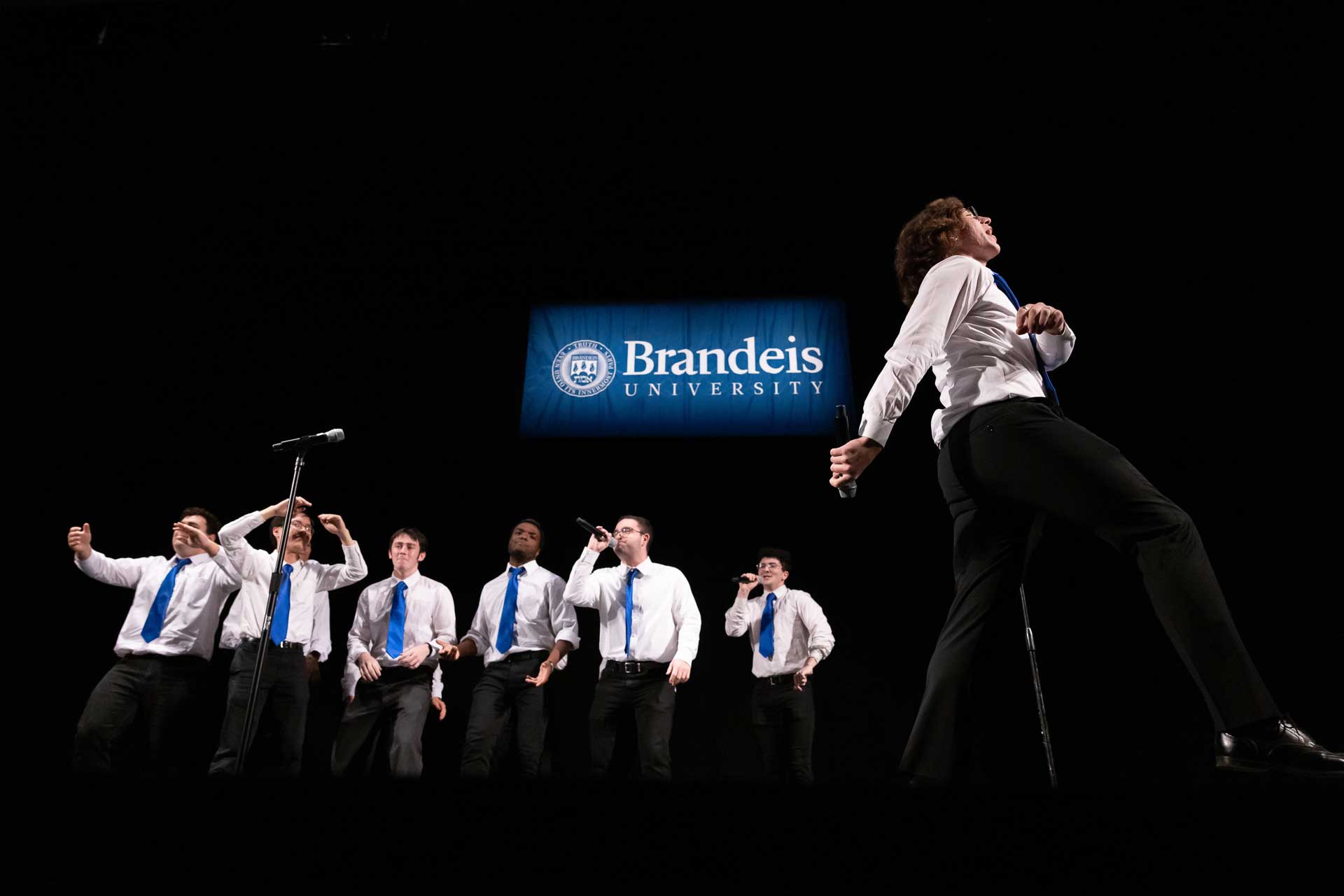 Students sing and perform on stage.