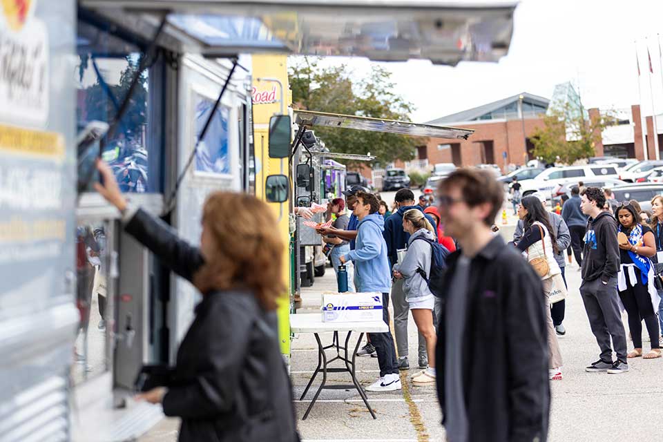 People wait in line at food trucks