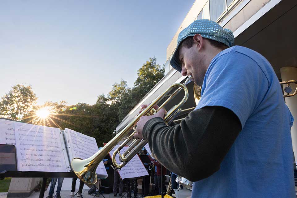 A student plays the trumpet during a performance at the Welcome Reception