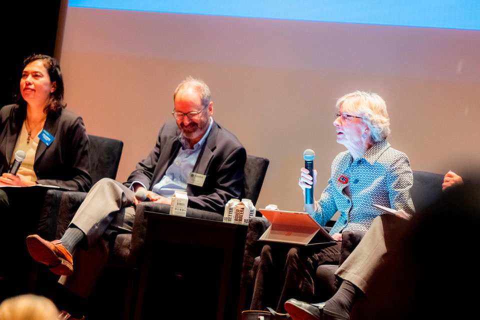 Panelist sit in chairs