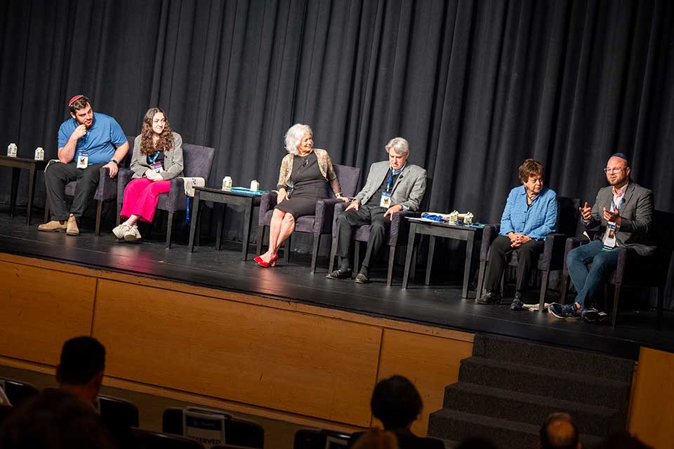 Panelists sitting on a stage