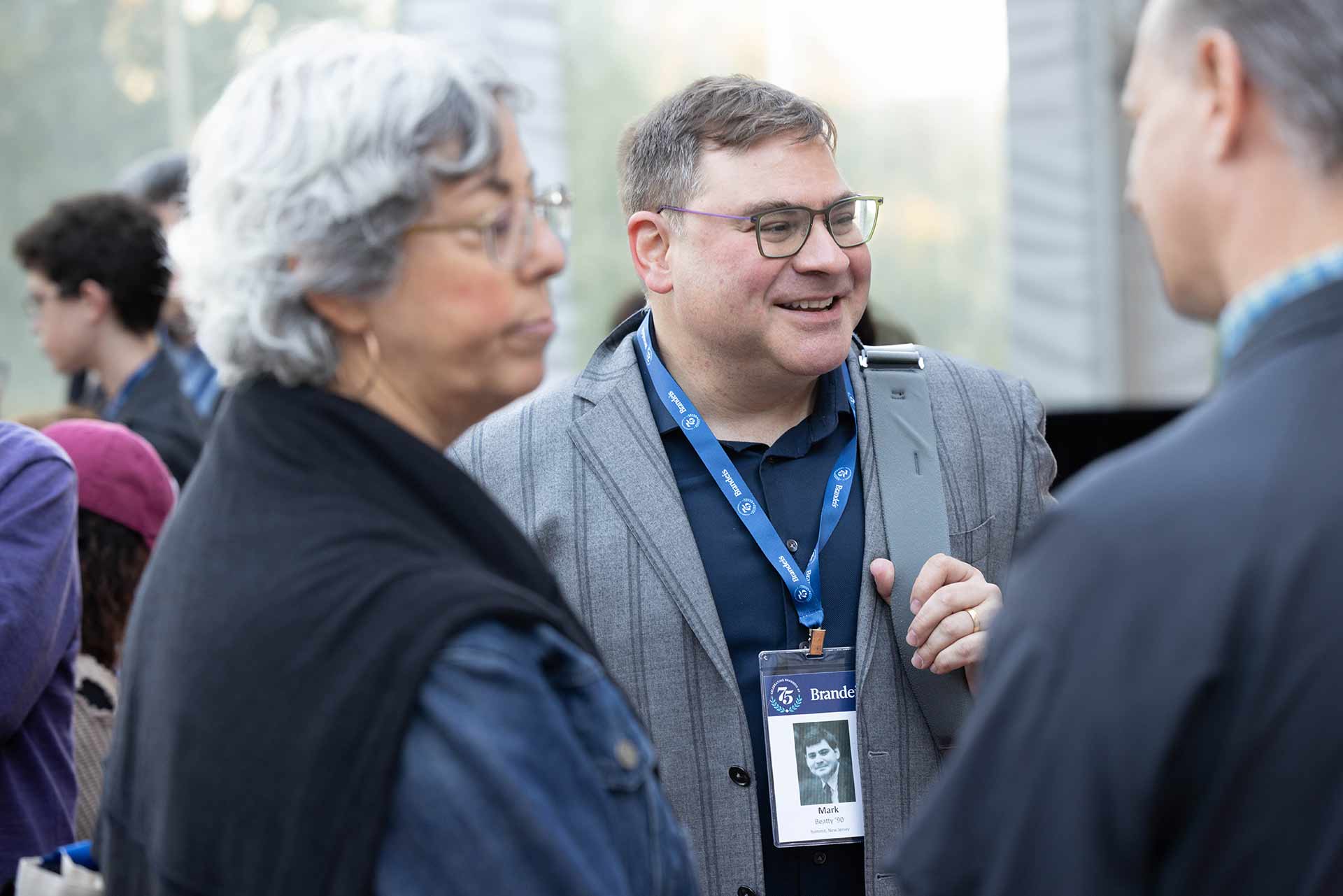 Person wearing a suit and name tag