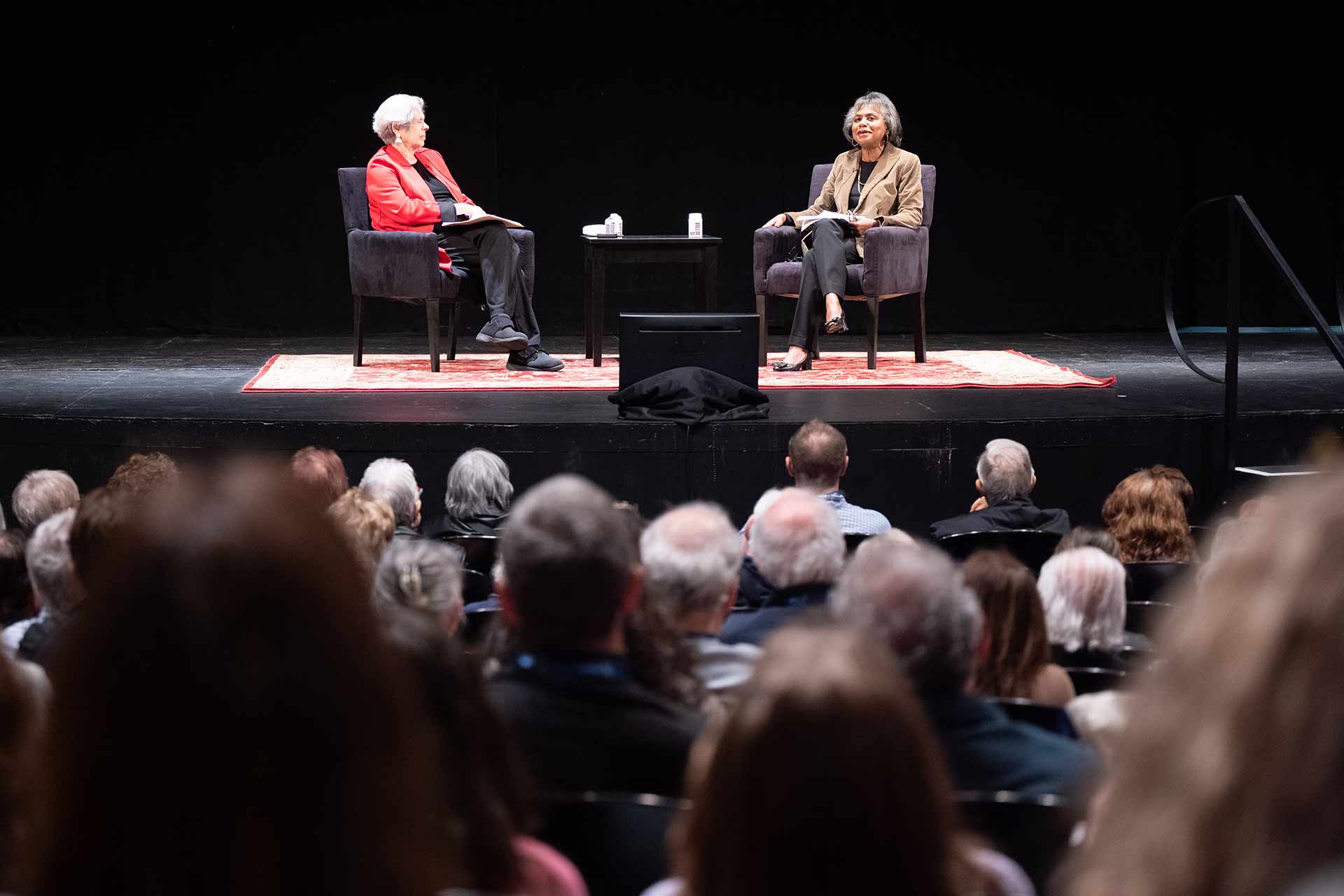 Joyce Antler and Anita Hill on stage in front of an audience