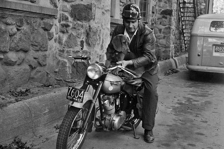 Ralph Norman and his black-and-tan coonhound, Cholmondeley, on a motorcycle