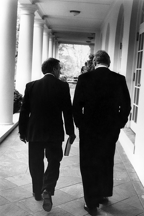 View of the backs of Eli Segal and President Bill Clinton at the White House