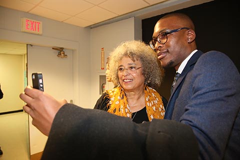 Student takes a selfie with Angela Davis