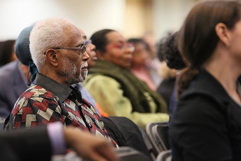 Person in audience watches the program