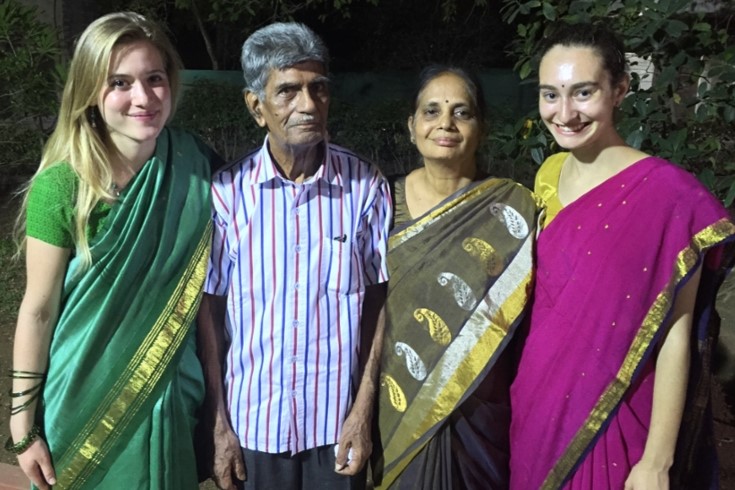 Annie Fortnow with a friend and local family in India