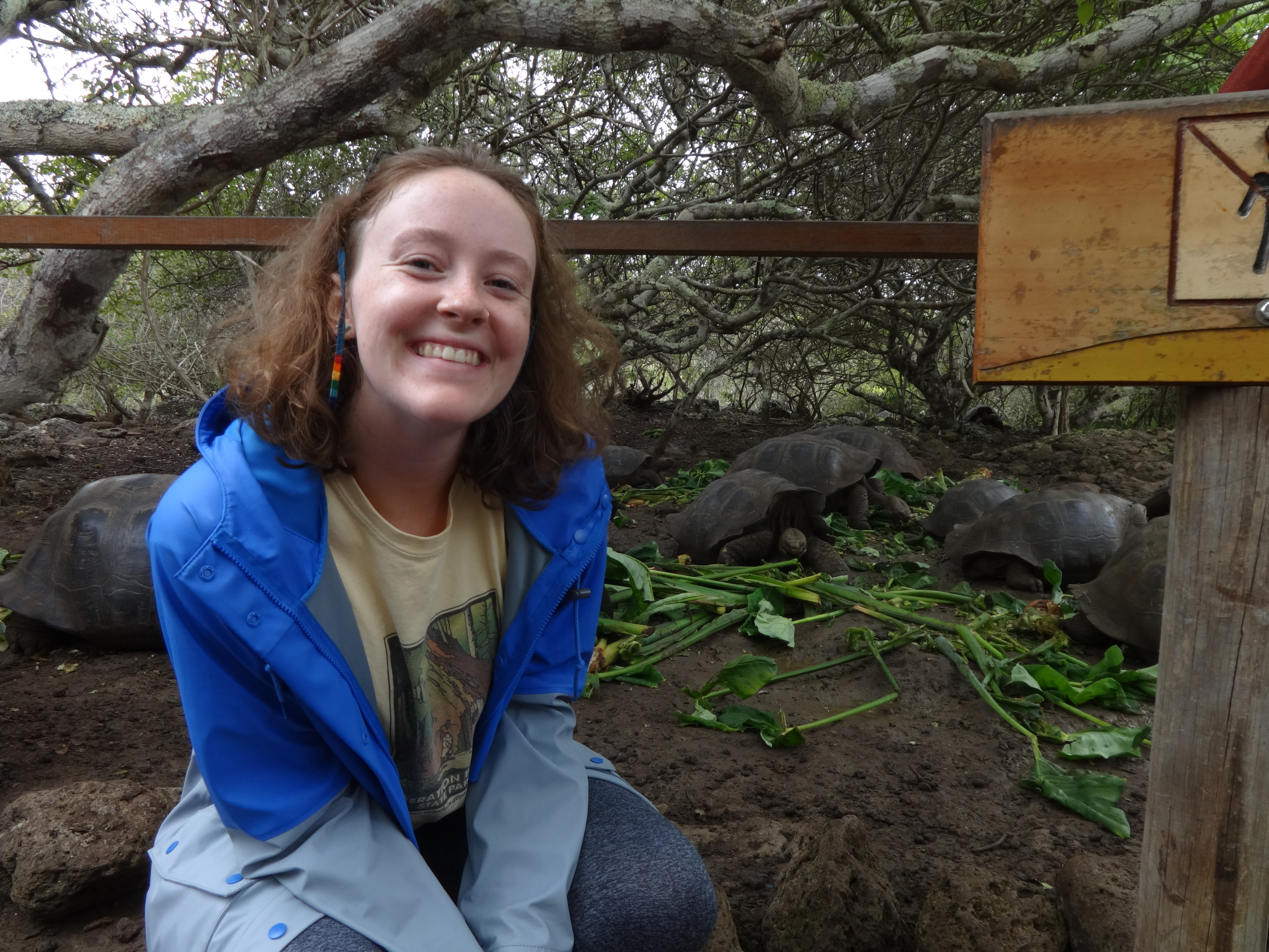 Libby posing in front of a group of turtles.
