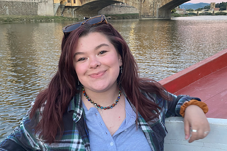 Skye Spinner on a boat along the river in Florence