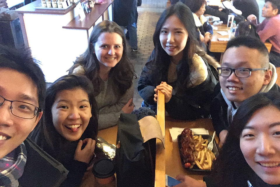 Exchange students sit around a table