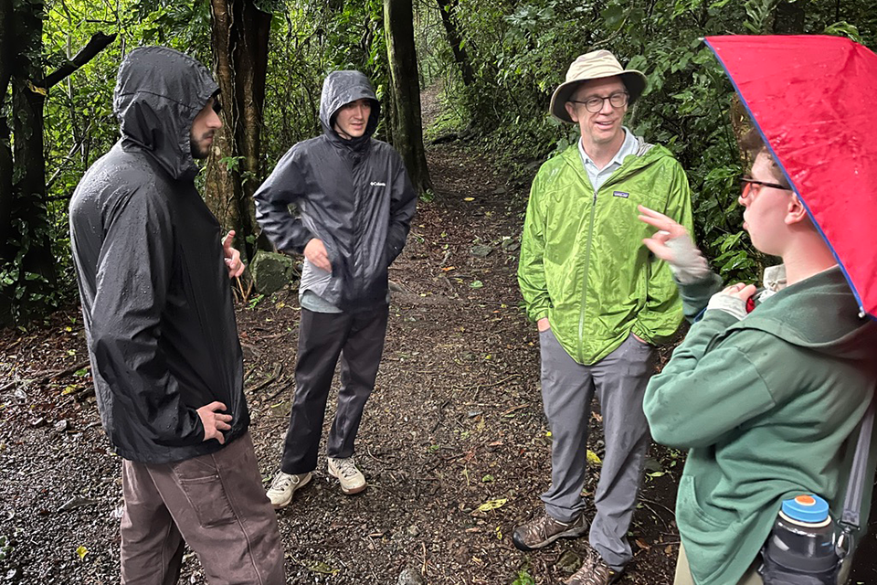 Brandeis students in the forest with Professor Charlie Chester