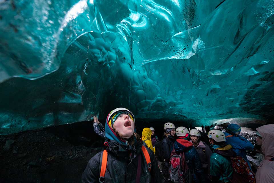 Students looking up at a sheet of ice 