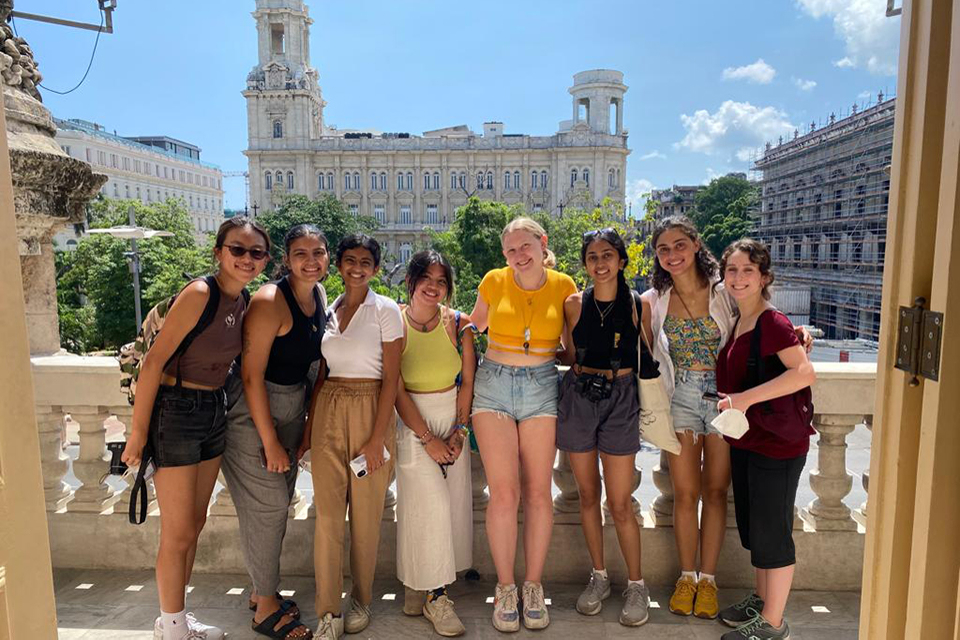 Students pose in front of an historic site in Havana, Cuba