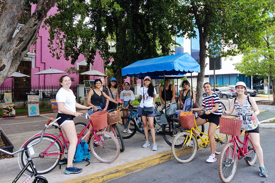 Students paused during a bicycle ride on a main street in Merida.