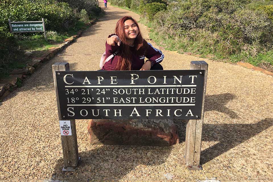 Zoila in front of Cape of Good Hope sign pointing