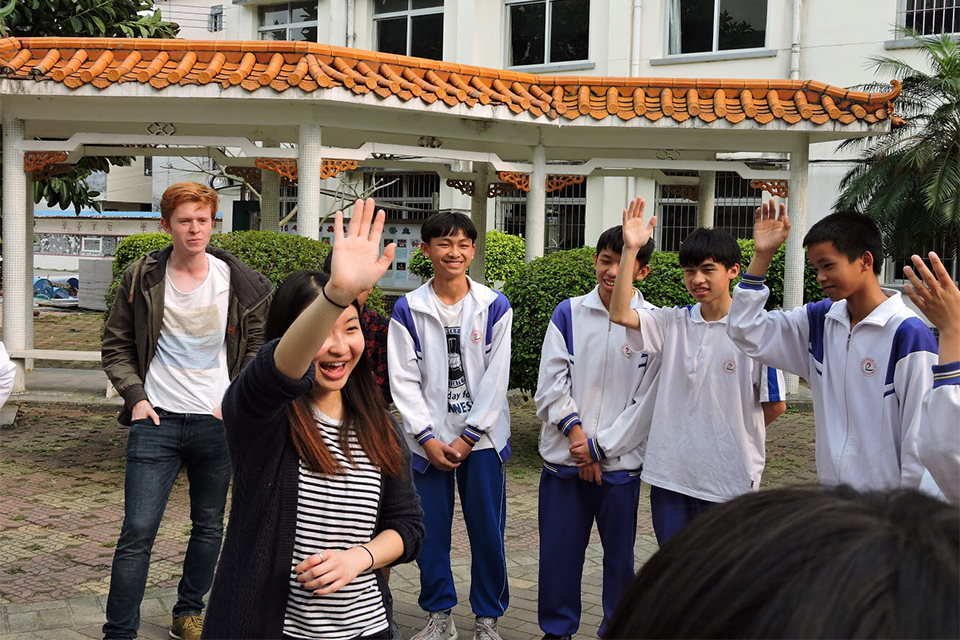 Stephanie with school students giving high fives