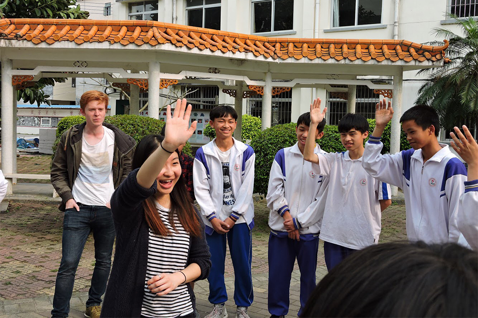 Stephanie with school students giving high fives