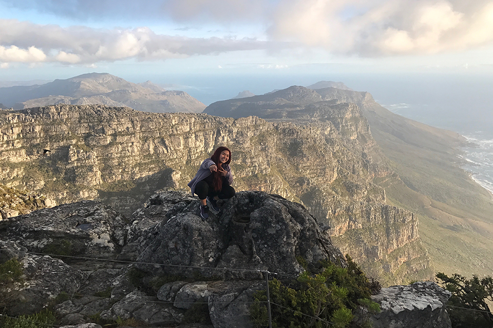 Zoila Coc-Chang on top of a mountain in South Africa