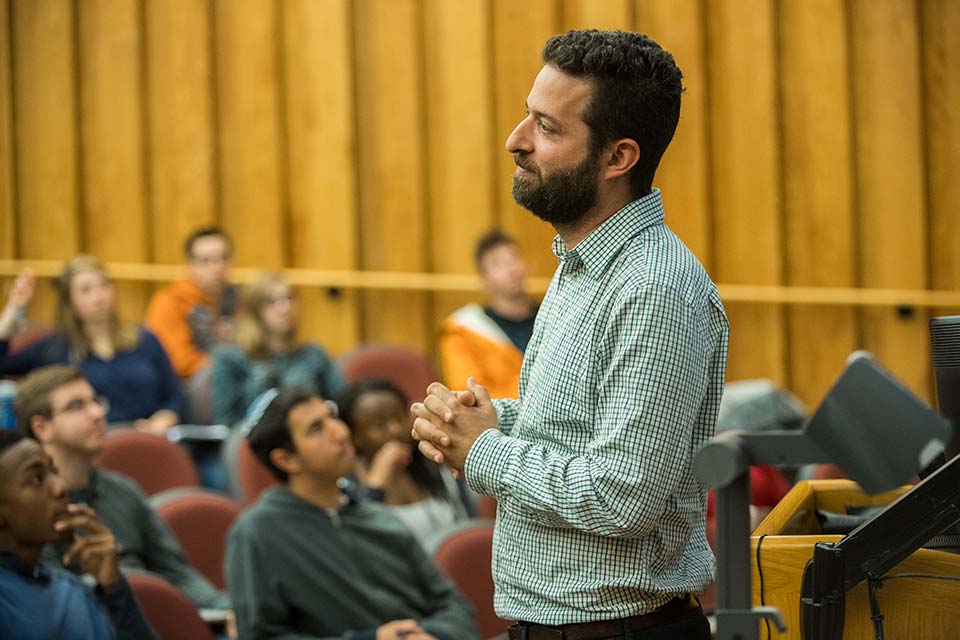 Professor Anjaria in the front of a lecture classroom full of students