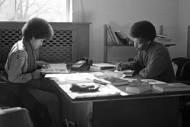 Black and white photo of two students in 1974 working at a desk