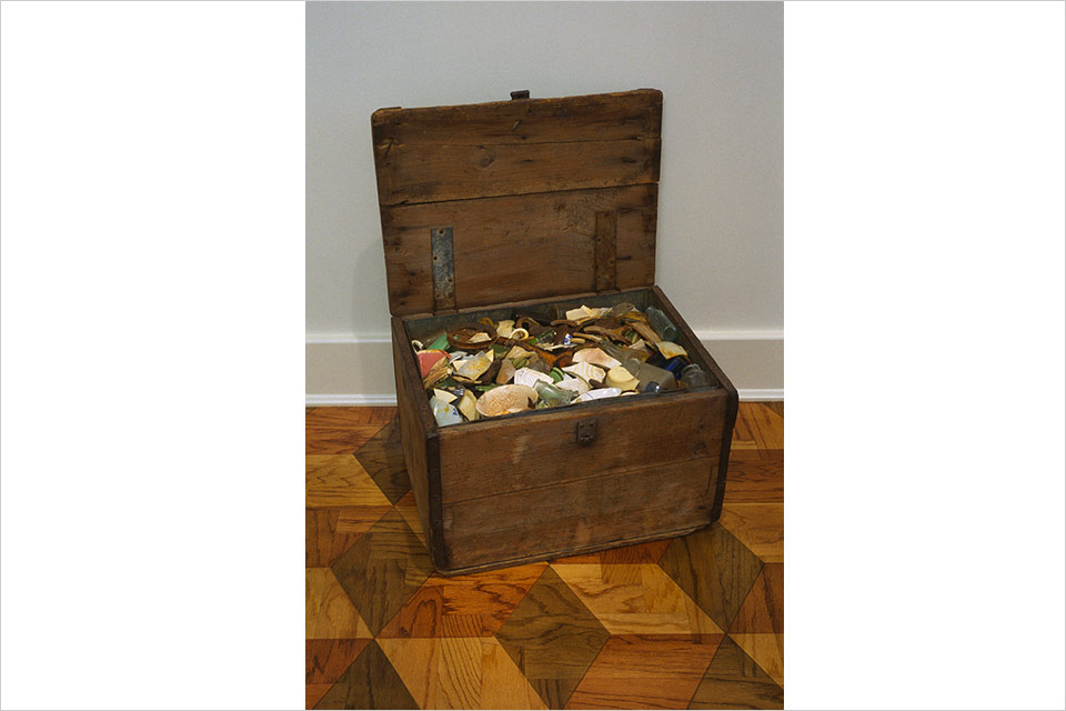 Wooden treasure chest filled with colorful metal objects