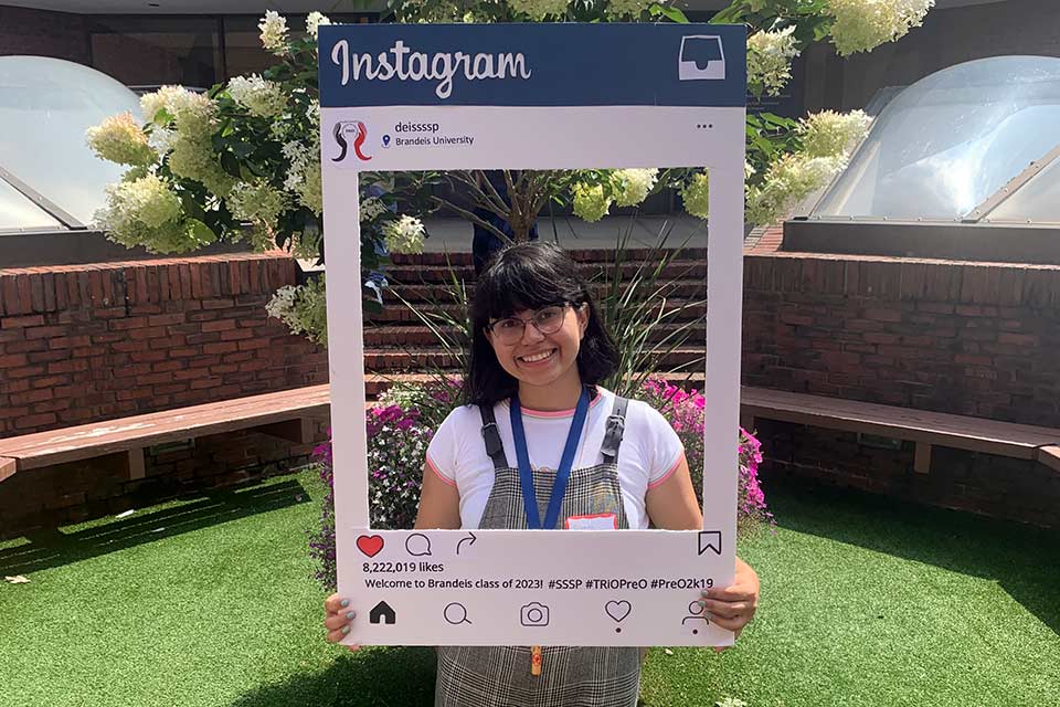 Student posing with an Instagram frame