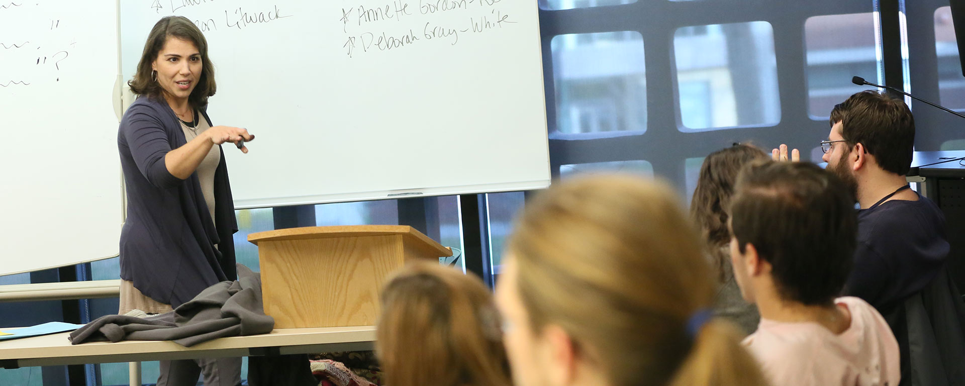 Professor Abigail Cooper engaged in discussion with her class