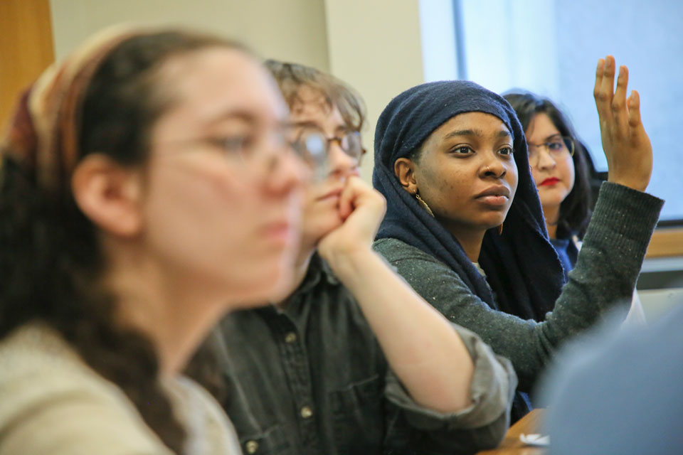 A student raises their hand in class