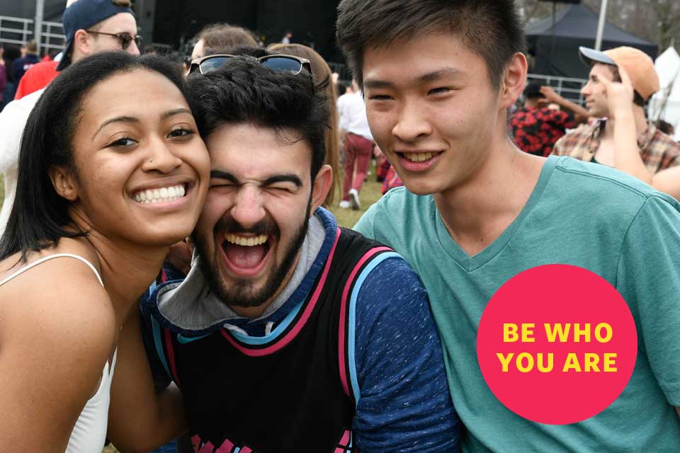 Happy students huddled together at an outdoor event