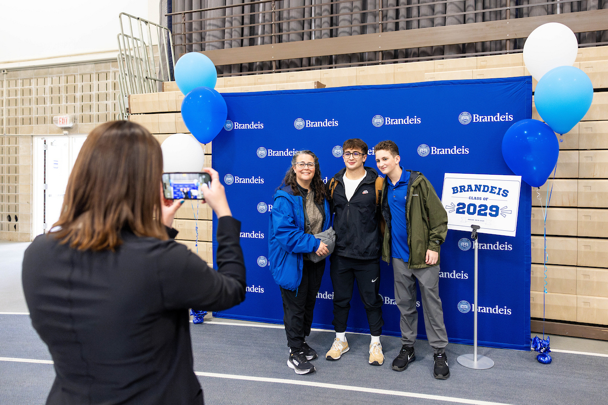 Two students pose with an owl mascot