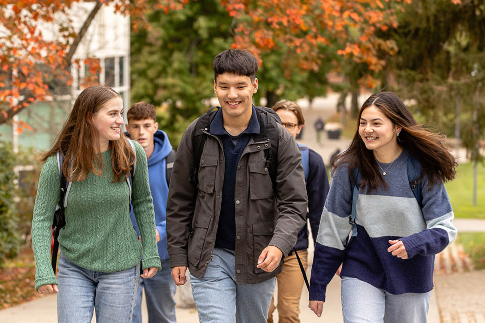 Three students walk outside