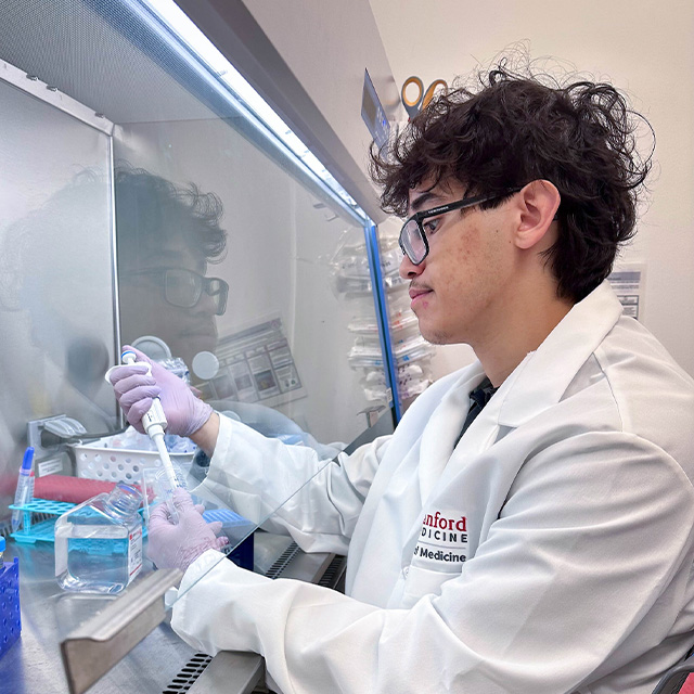 Walid stands at a lab bench 