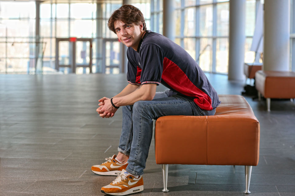 Archie sitting on a bench with elbows on knees