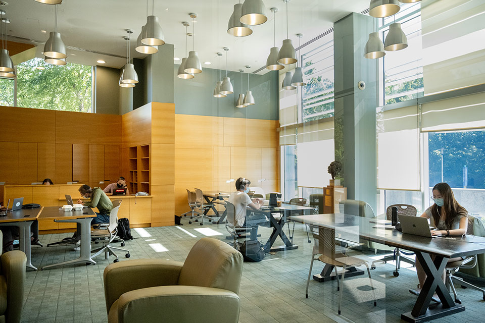 Students seated physically distanced in the study library of the Shapiro Campus Center