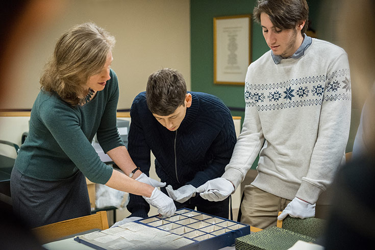 Students observing items in the Archives