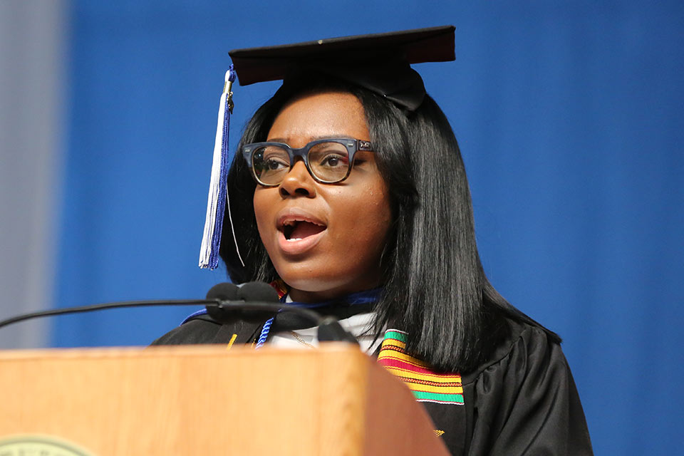 Mercedes Hall speaking at a podium at Commencement