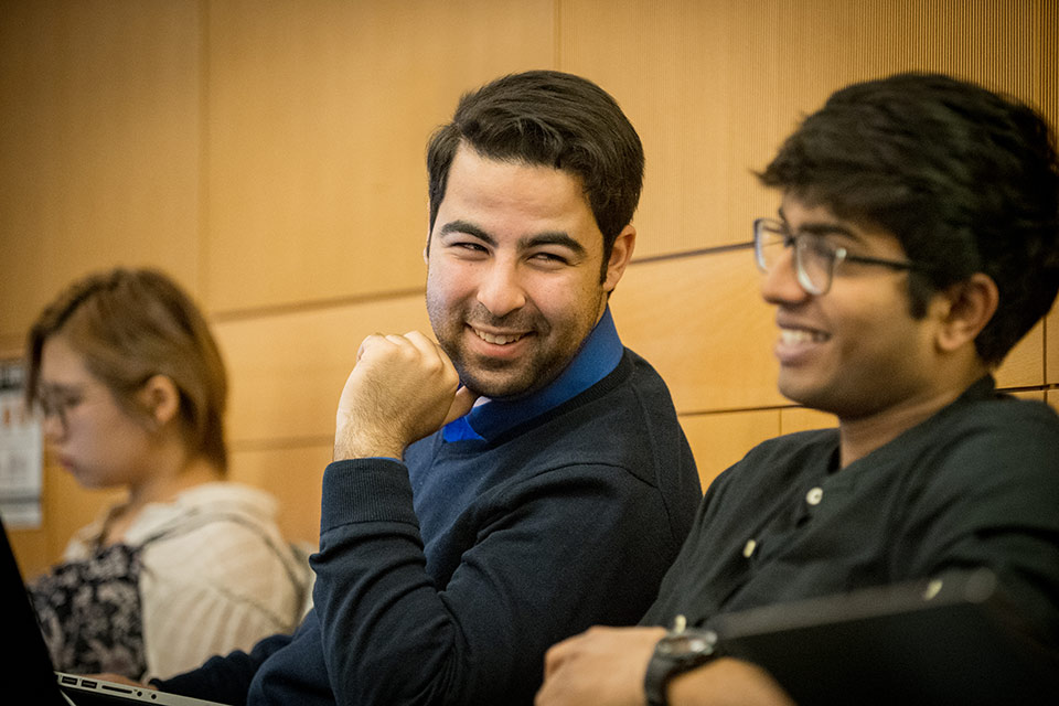 Two students smiling in class