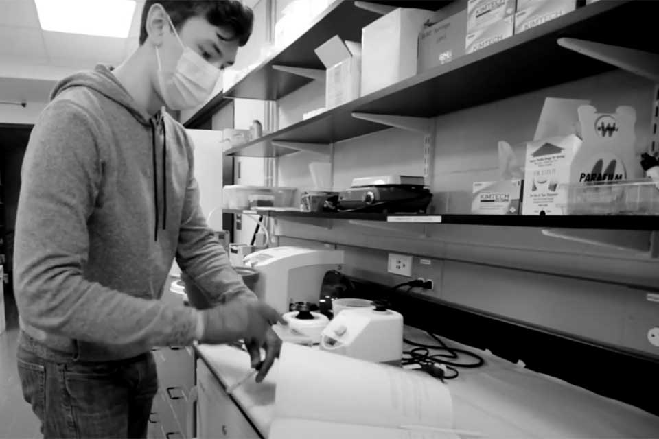 Student turning a page in a lab