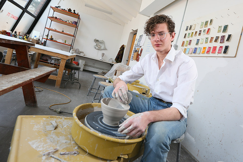 A student making pottery